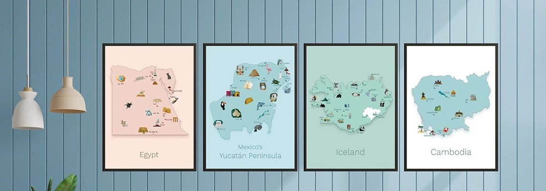 4 black poster frames are filled with illustrated maps. One of Egypt in brown tones, one of the Yucatan Peninsula in blue tones, one of Iceland in green tones and a white and blue one of Cambodia. The hang on a pastel blue wall with a wooden cabinet underneath the wall art.