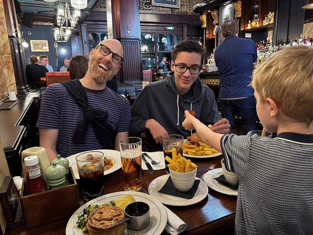 A father and his 2 sons having dinner in a pub